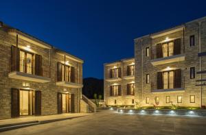 a pair of buildings at night at Aelia Sivota in Syvota