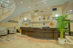 a lobby with a waiting area with a reception desk at Hayah Grand Hotel in Al Madinah