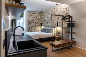 a kitchen with a sink and a bed in a room at The Place - Only Self Check-in - No Reception in Trento