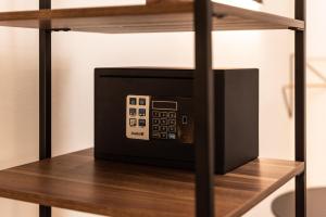 a microwave sitting on top of a wooden shelf at The Place - Only Self Check-in - No Reception in Trento
