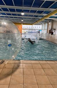 two large inflatable balls on a pool of water at Cornish coastal retreats- 74 newquay view in Porth
