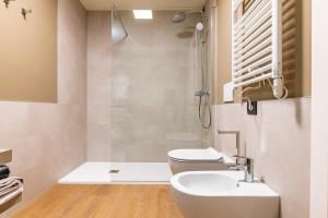 a bathroom with a toilet and a sink and a shower at The Place - Only Self Check-in - No Reception in Trento