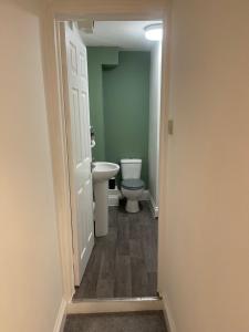 a bathroom with a toilet and a sink at Cosy entire apartment super king bed near town center in Colchester