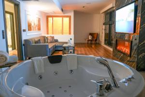 a large bath tub in a living room with a fireplace at Flora Ordu Hotel Apart Suite in Ordu +110 photos