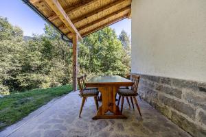 una mesa de madera y sillas en un patio en Baita Cisina, 