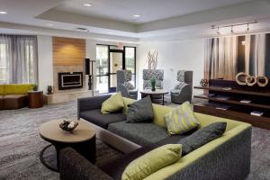 a living room with two couches and a fireplace at Courtyard by Marriott Stockton in Stockton
