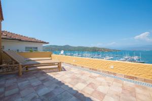a patio with a bench and a view of the water at Hotel Unique-Boutique Class - Adults Only in Fethiye
