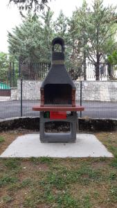 a barbecue grill sitting on top of a field at Residence Fonte Eremita in Roccaraso
