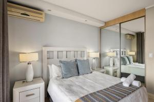 a bedroom with a bed and a large mirror at Hydro Park Residences in Sandton WITH GENERATOR in Johannesburg