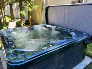 a large tub with water in it in a yard at Villa Adis with Hot Jacuzzi & Sauna in Borovets