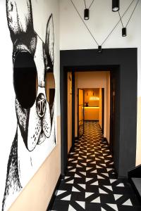 a hallway with a painting of a llama wearing sunglasses at Hotel AVAlex in Berlin