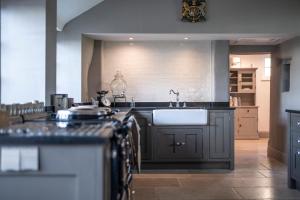 a kitchen with a sink and a counter at Georgian Country House -Panoramic Views -Sleeps 12 in Ruthin