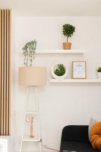 a living room with a ladder and plants on shelves at Super Modern 2BD Central Home in Belfast