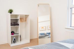 a bedroom with a mirror and a bed at Super Modern 2BD Central Home in Belfast