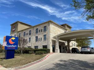 a hotel with a sign in front of a building at Comfort Suites Near Seaworld in San Antonio