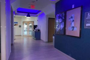 a hallway with a blue wall and purple lights at Comfort Suites Near Seaworld in San Antonio +25 photos