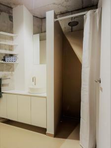 a bathroom with white cabinets and a sink at Haus Moosberg - Erholung bei Seeblick und Ruhe in Gmunden