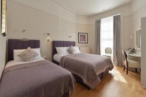 Postel nebo postele na pokoji v ubytování Harlingford Hotel