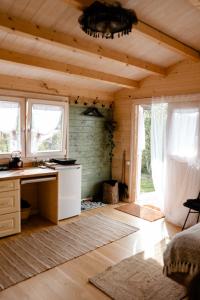 a room with a desk and windows in a cabin at Ambercoast in Jūrmala