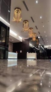 a lobby with chandeliers and a shiny floor at D' Pines -Family Suite in Melaka