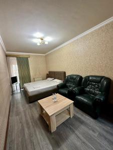 a living room with a couch and a bed at Giza in Yerevan