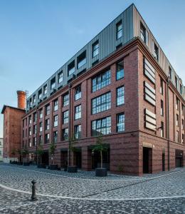 un gran edificio de ladrillo rojo en una calle en Landmark Apartments, en Cracovia