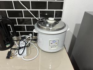 a slow cooker sitting on top of a counter at DHIA HOMESTAY in Machang