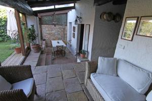 a patio with a couch and a table and chairs at Casa acogedora en Begur in Begur