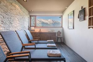 a room with chairs and a table and a window at Mountain Chalet Obertreyen in Campo Tures