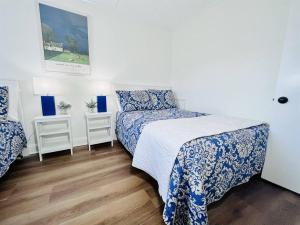 a bedroom with two beds with blue and white sheets at Beach Front Condo with Spectacular Views in Ocean City