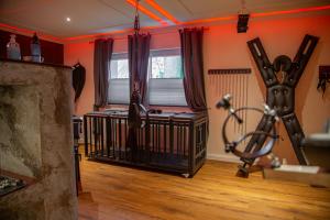 a room with a gym with a treadmill in a room at exkl. romantisches SM Apartment Black Rose in Gifhorn