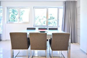 comedor con mesa azul y sillas en Relaxing 3BR in Ben yehuda 66 by HolyGuest, en Tel Aviv