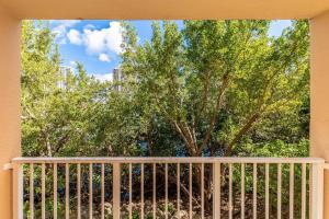 a balcony with a fence and a tree at Luxury VIP 3 Bed 2 Bath Apartment Yacht Club Aventura in Miami
