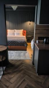 a bedroom with a bed with a black headboard at Central Gate apartment in Chernivtsi