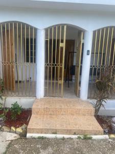 a entry to a house with a gate at 3-Bed House in Montego Bay 10 min from airport in Montego Bay