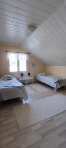 a bedroom with two beds and a ceiling at Villa Koivikko in Rovaniemi