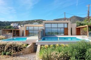 a villa with a swimming pool and a house at Mirabella Hills in Agios Nikolaos