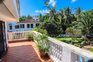 a balcony of a house with palm trees at MJ MARINA, Fastcare Mtwapa Creek in Mombasa