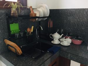 a kitchen counter with a sink with utensils at Sathis villa in Ambalangoda