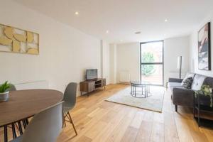 a living room with a table and a couch at Stylish East London Flat MS2 in London