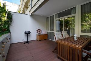 a patio with a table and chairs on a deck at Relaxing home I Balcony I Free parking I Garden in Budapest