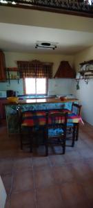 a kitchen with a table and chairs in a room at La Lobera Alojamiento Rural in Riópar