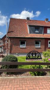 a wooden bench in front of a brick house at Ferienwohnung Bad Harzburg Grubenweg 34 in Bad Harzburg