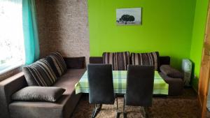 a living room with a couch and a table and chairs at Ferienhaus Baake in Mönkebude