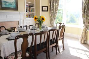 a dining room with a table with sunflowers on it at Lake District 4 Bedroom House, Ings, Cumbria. in Kendal