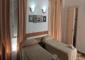 Łóżko lub łóżka w pokoju w obiekcie Hotel Betania
