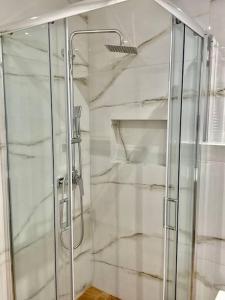 a shower with a glass door in a bathroom at Relax Home in Moschato 2 vipgreece in Piraeus