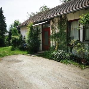 a small house with a dirt road in front of it at Cosy room in the nature in Graz
