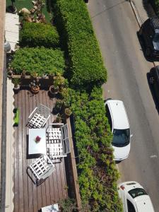 an aerial view of a white car parked on a street at near the sea even 14 days won't feel enough in Tel Aviv