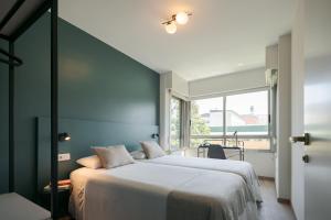 Posteľ alebo postele v izbe v ubytovaní Someso Apartamentos Turisticos